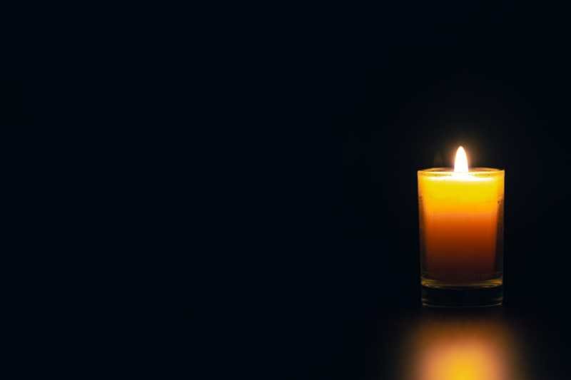 _burning-candle-black-background