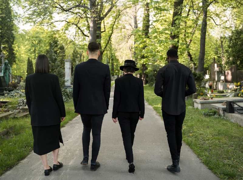four-persone-leaving-funeral-venue