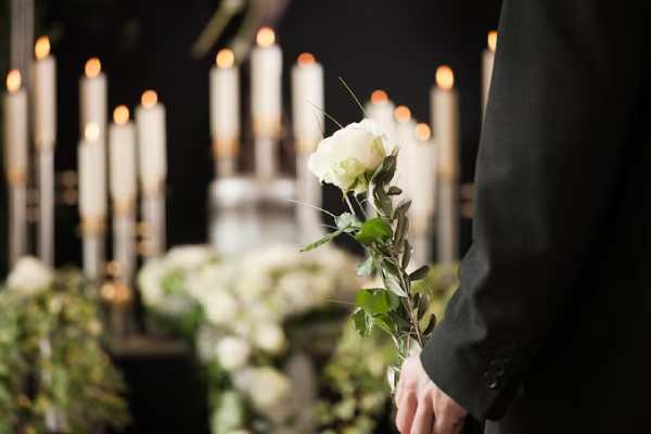 woman-holding-white-flower-funeral